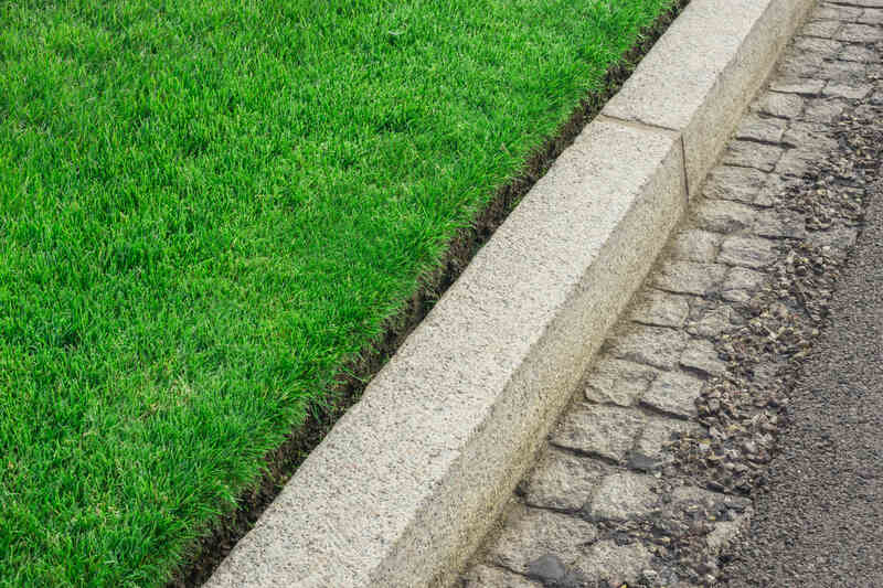 Clean lawn edging along sidewalk and curb on a Sioux Falls property