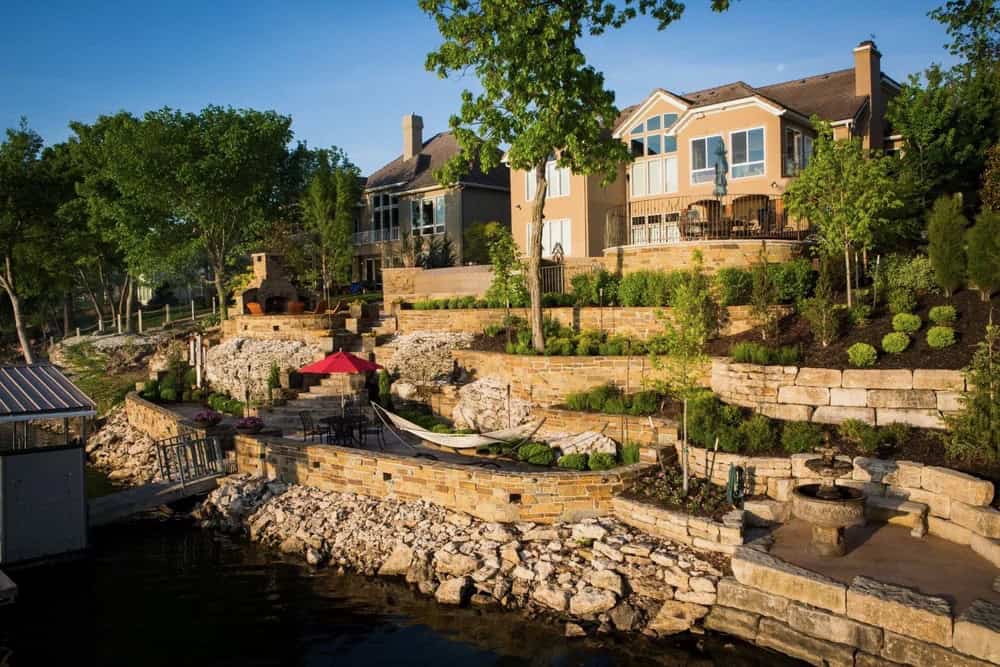 Custom multi-level hardscape with stone retaining walls and outdoor living terraces built for lasting performance.